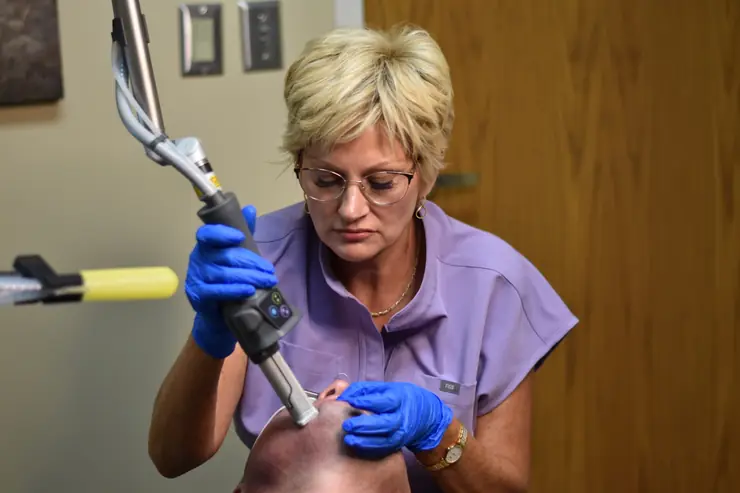 Haley S. Wilmoth, RN, BSN, using the Cartessa HELIX laser during a treatment at the practice
