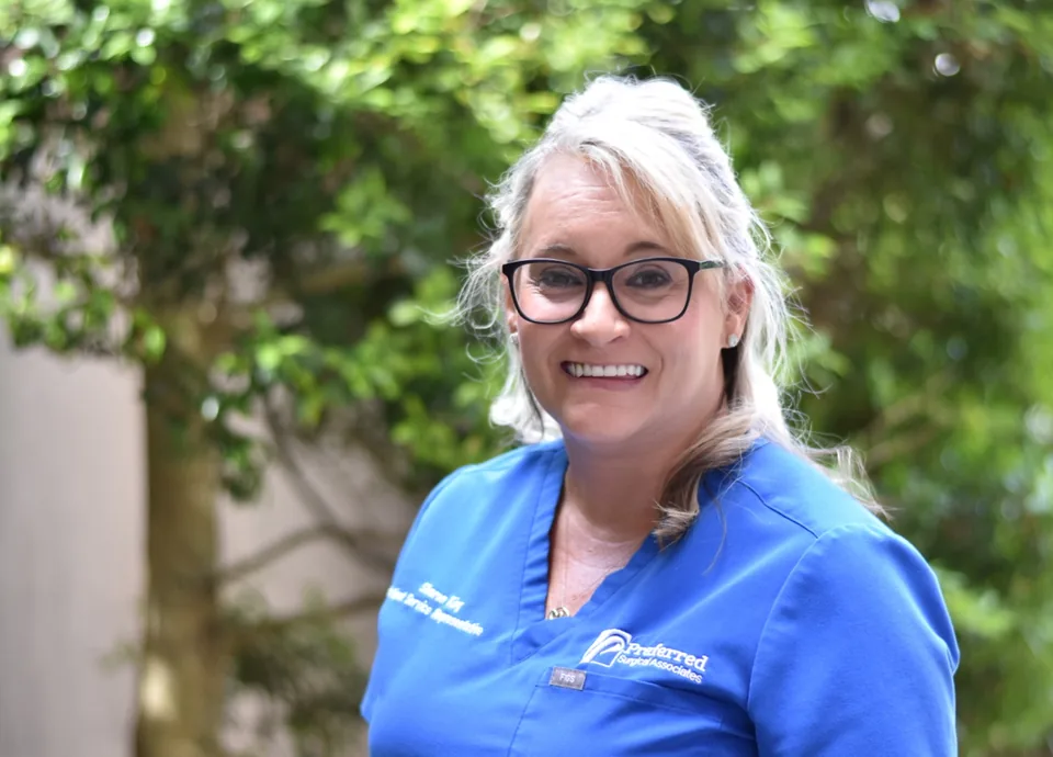 Sharon King, Patient Service Representative, in blue scrubs outdoors